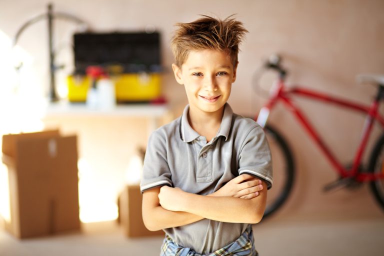 Child standing with arms crossed.